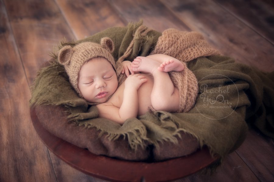 newborn baby boy in a wooden basket - newborn photography vancouver