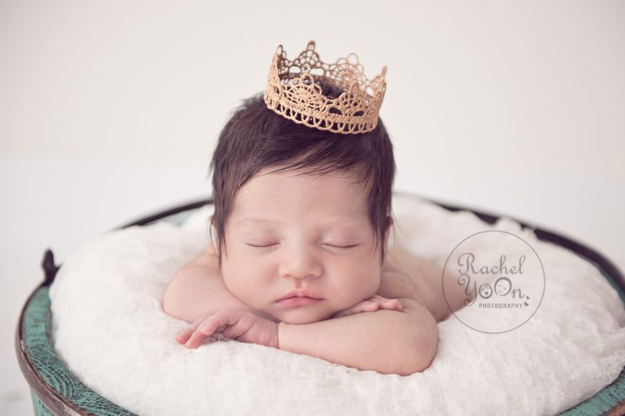 newborn baby girl with a crown on her head in a basket - newborn photography vancouver
