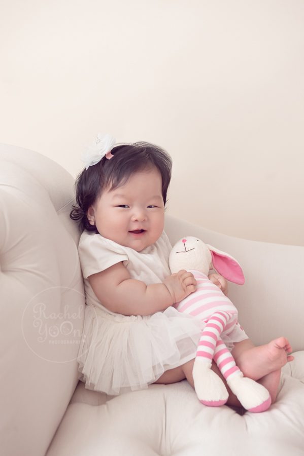 baby girl holding a stuffed animal - baby photography vancouver