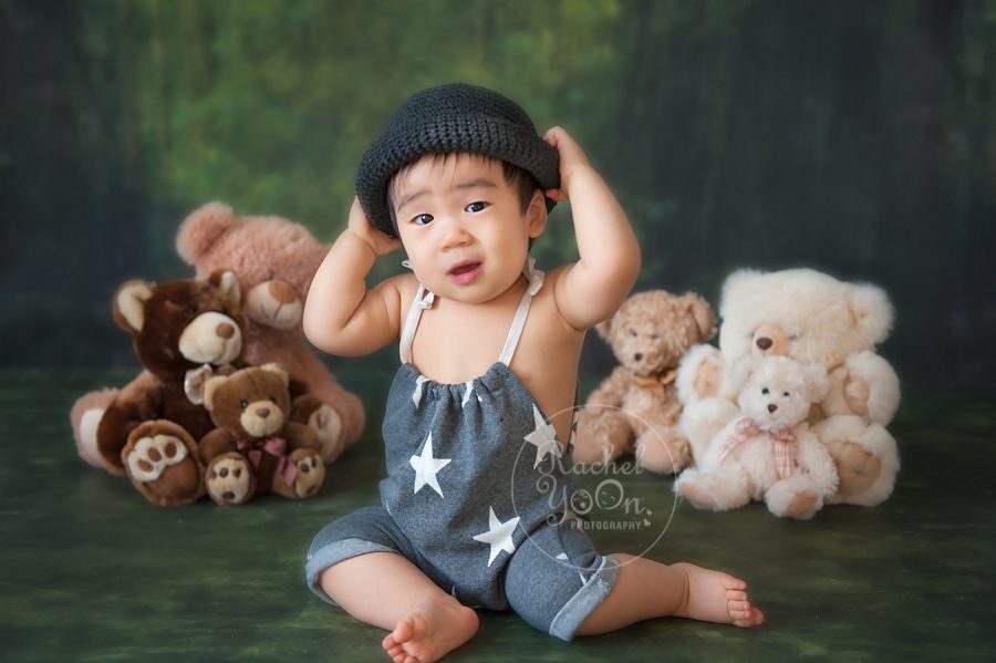 1 year old baby boy trying on a hat - baby photography vancouver