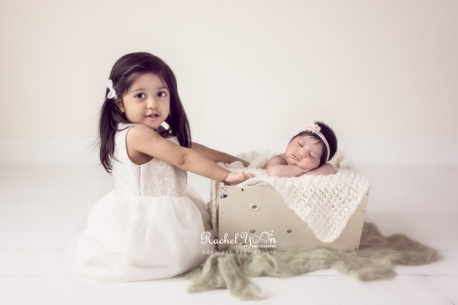 newborn baby girl with her sibling - newborn photography vancouver
