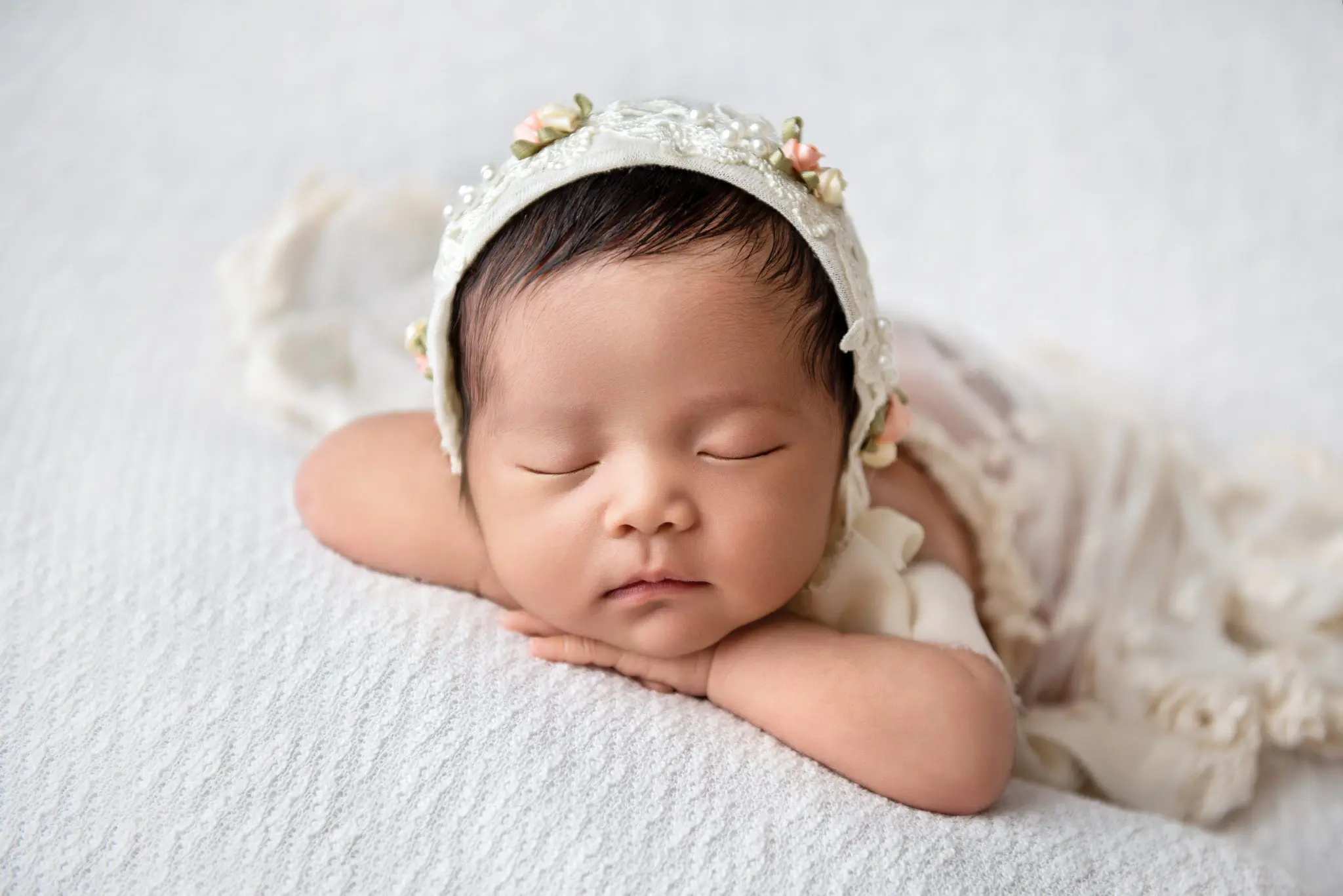 newborn photography vancouver - newborn baby girl with cream bonnet
