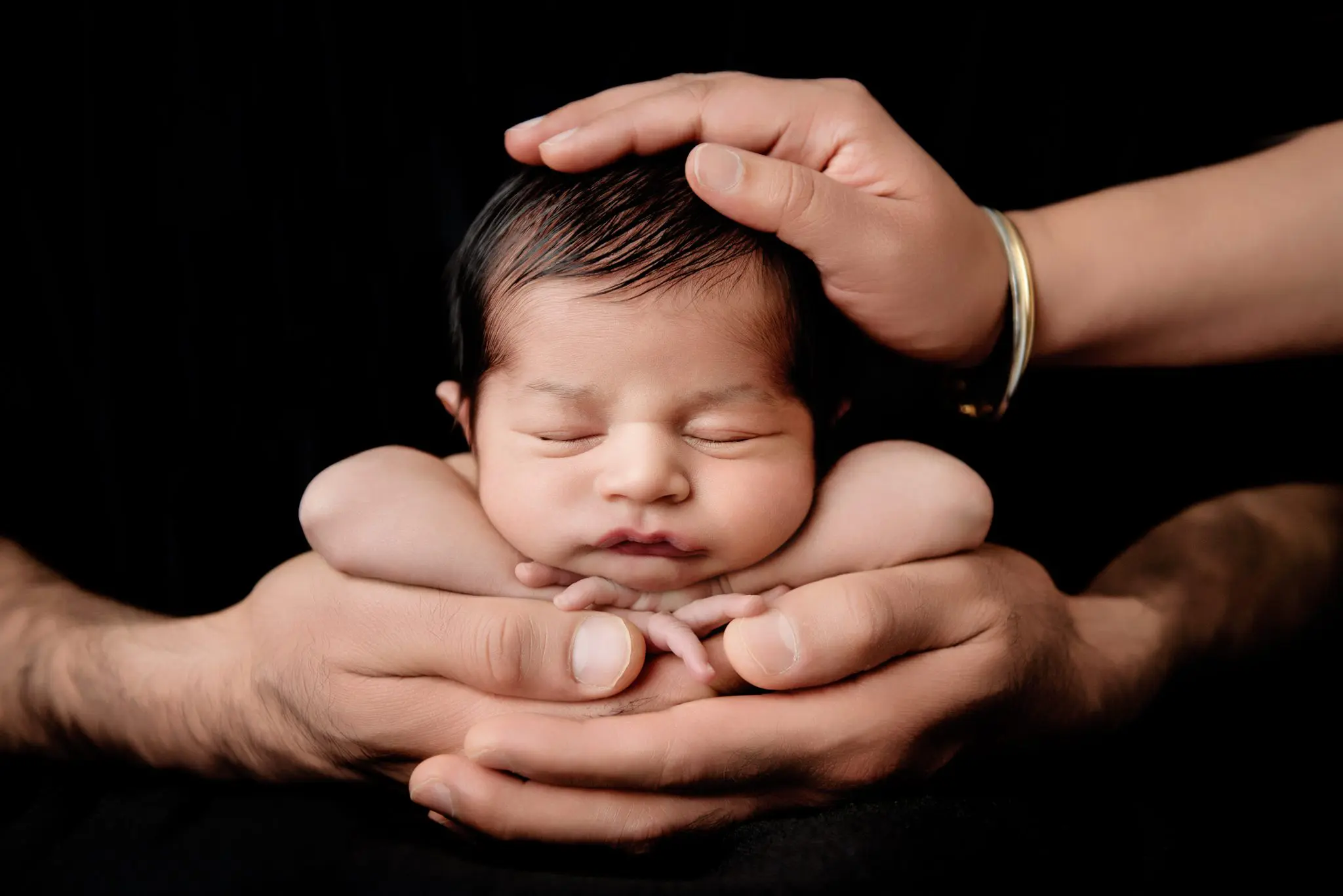 newborn photography vancouver - newborn baby with mom and dad's hands
