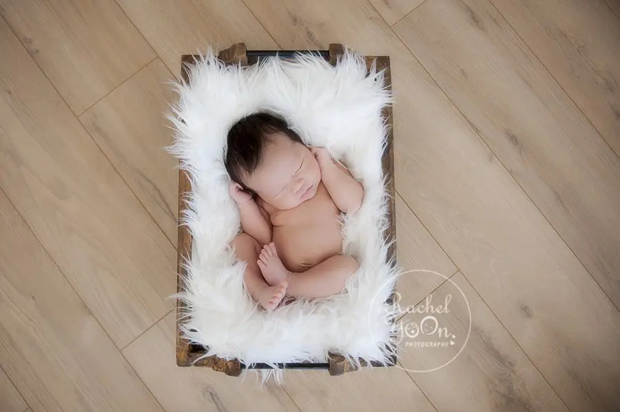 newborn baby boy in a wooden box - Vancouver Newborn Photographer