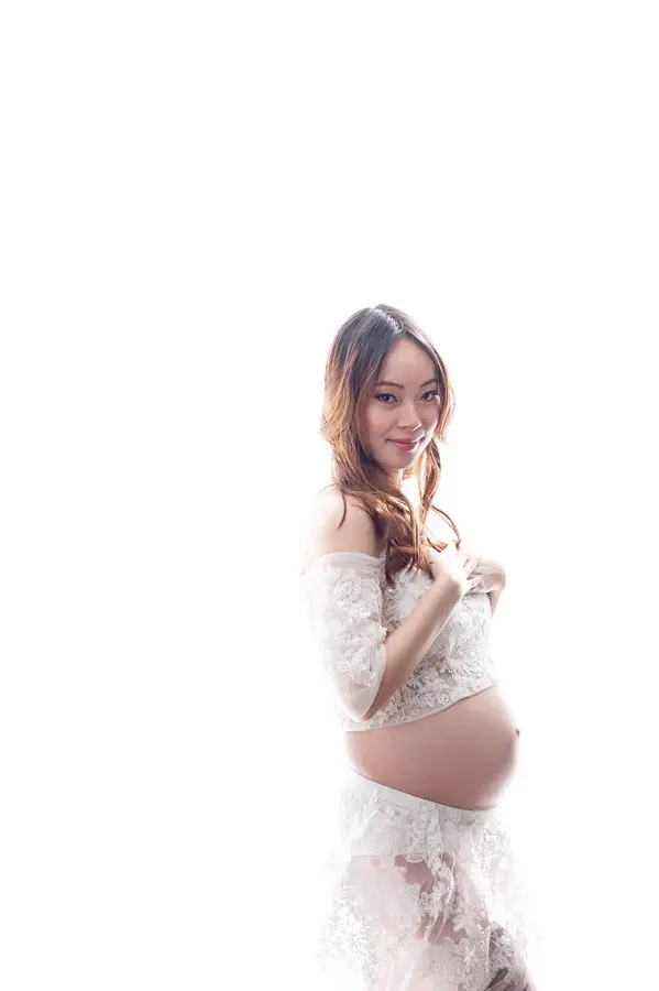 maternity pose in a lovely white dress with backlighting - maternity photography vancouver