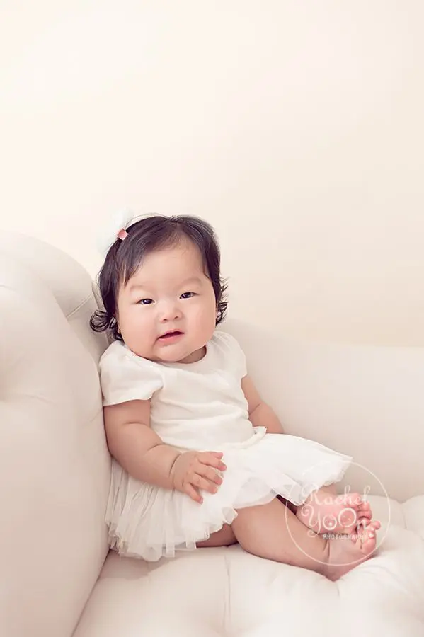 baby girl sitting on a couch - baby photography vancouver