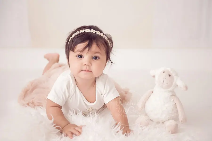 6 months old baby girl lying on her tummy - baby photography vancouver