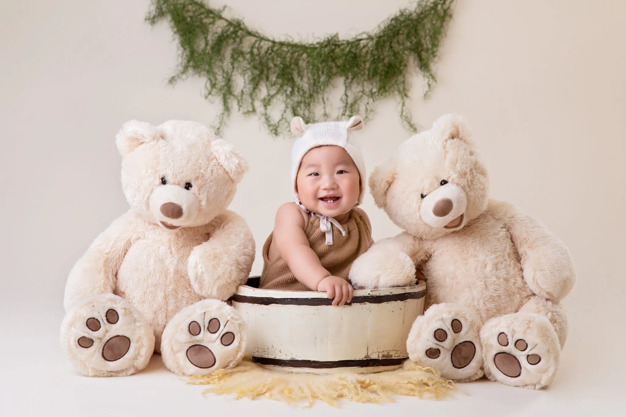 sitter session - baby sitting in a basket with teddy bears