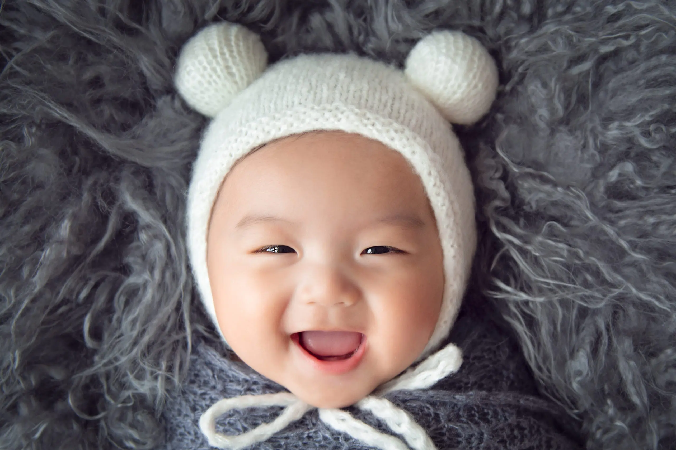 100 days old baby photography - baby boy with a bon bon bonnet