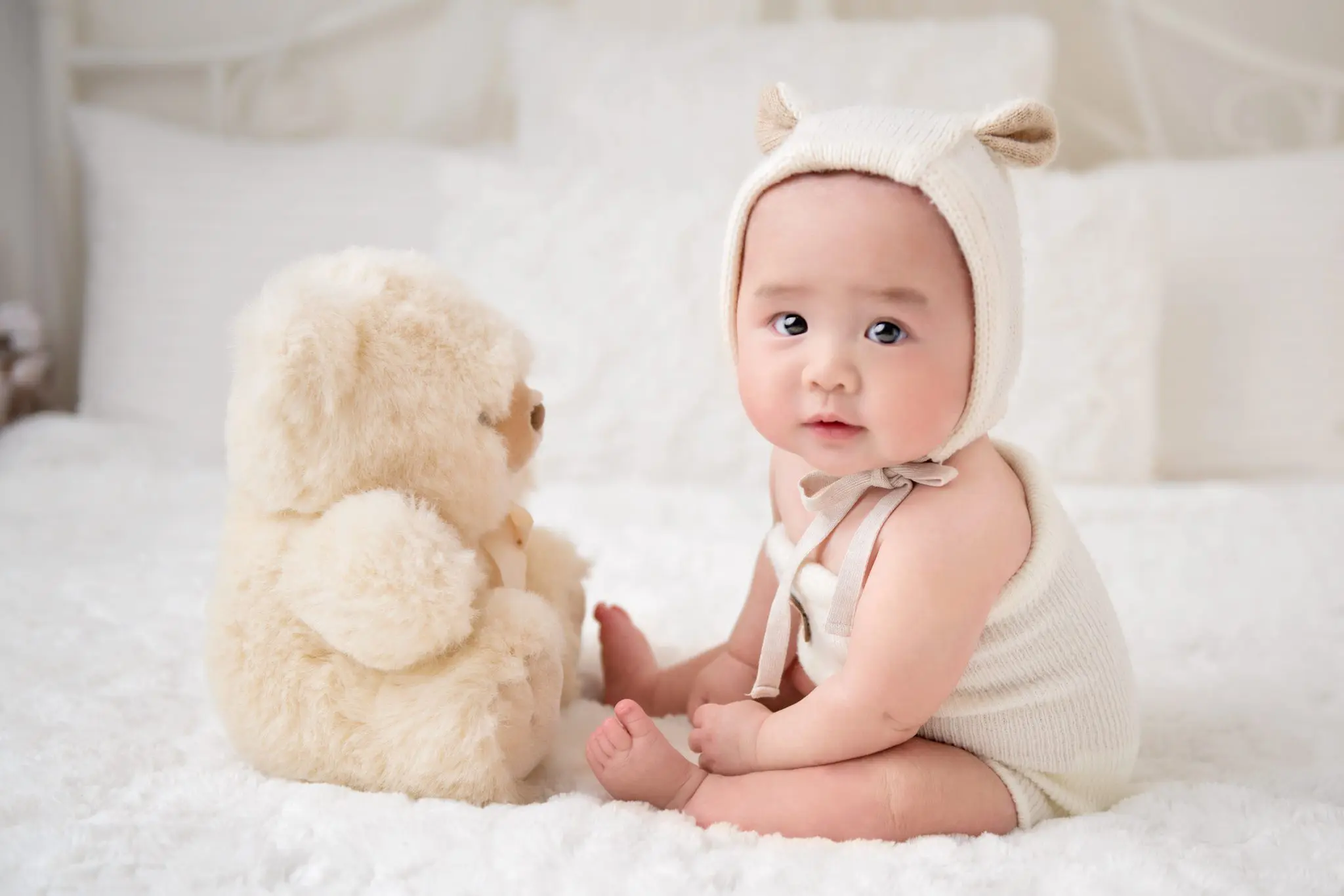 baby sitting up in front of the teddy bear - baby photography vancouver