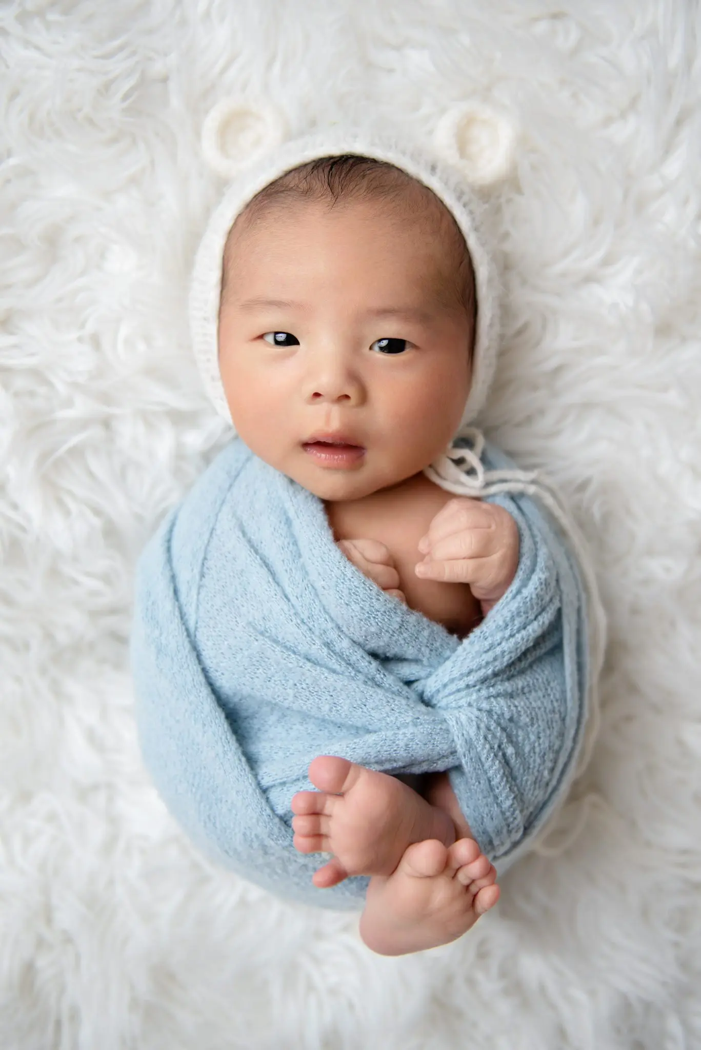 newborn baby wrapped in blue