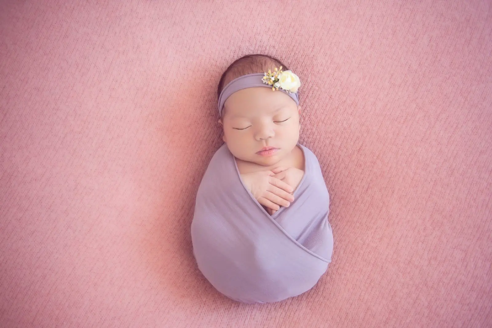 newborn photography - baby wrapped in purple