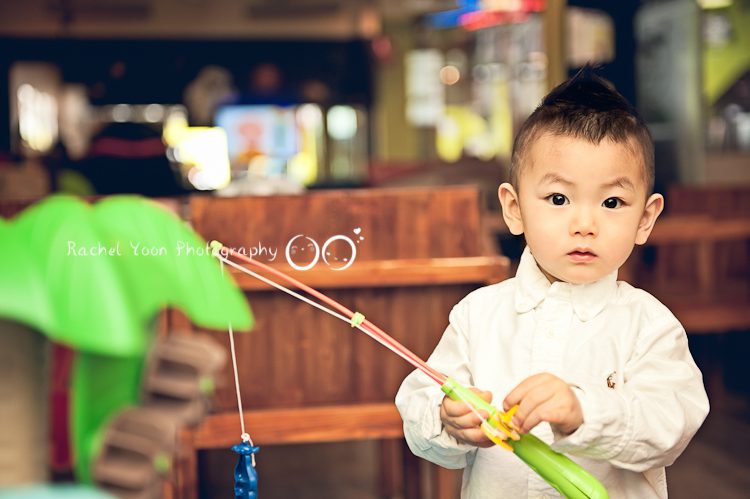 a boy holding a fishing toy