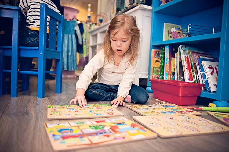 little girl playing with puzzles