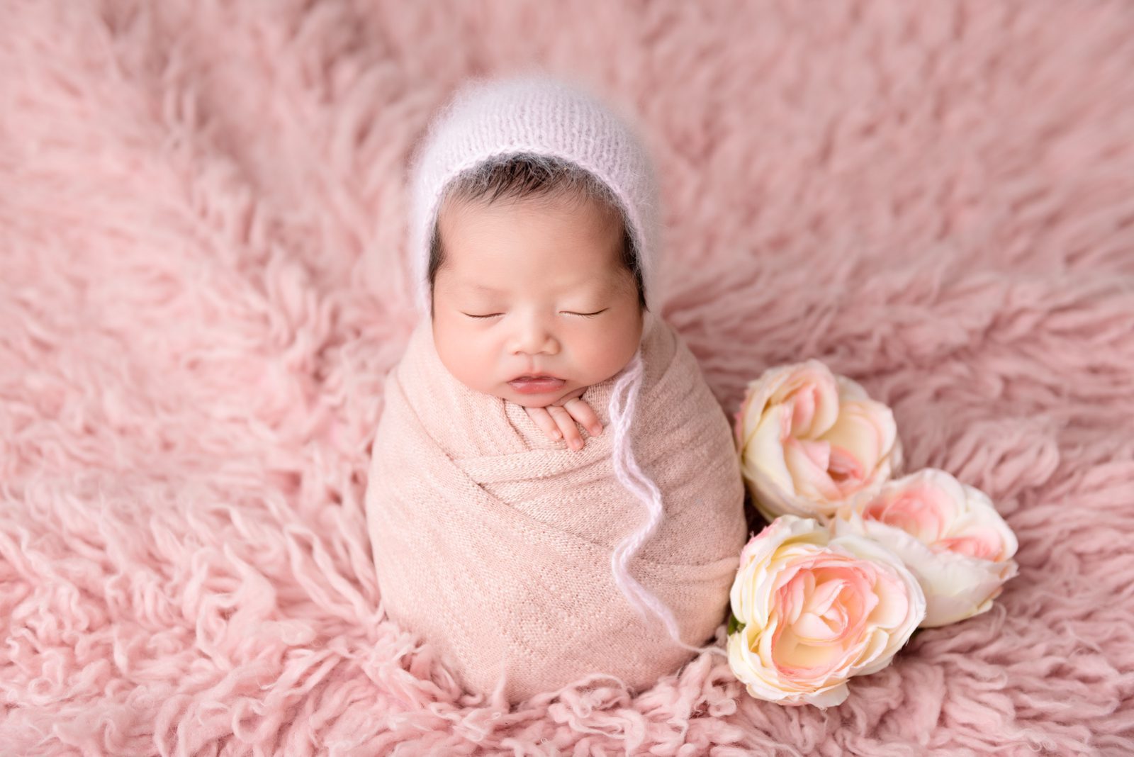 newborn photography - baby girl wrapped in pink - potato sack pose