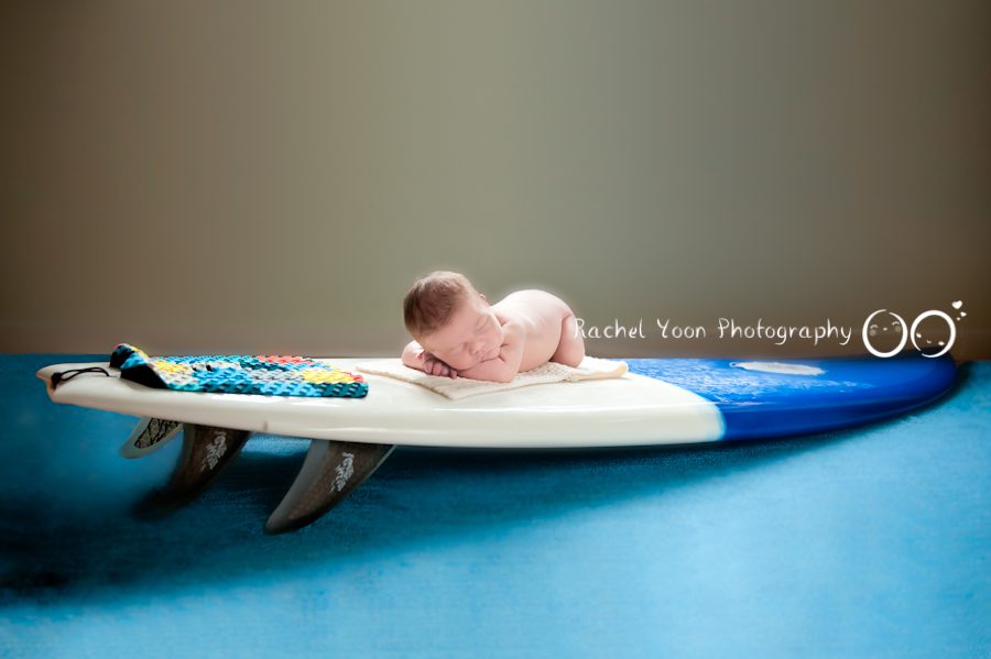 newborn photography vancouver - baby boy on a surfing board