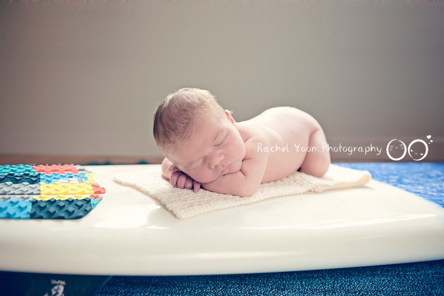 newborn photography vancouver - baby boy on a surfing board