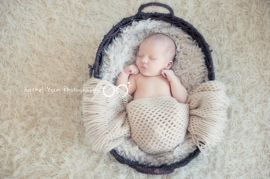 newborn baby photography - baby boy propped in a basket