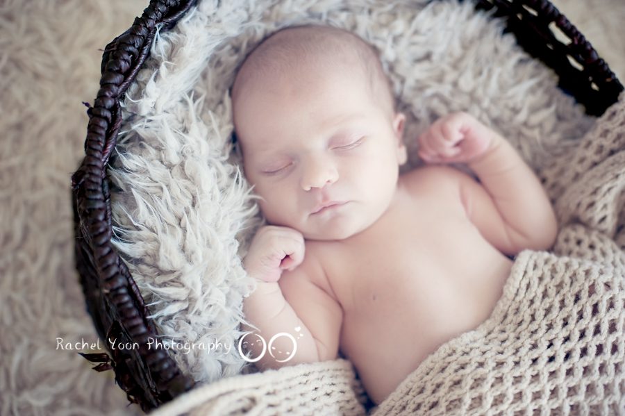 newborn baby photography - baby boy propped in a basket