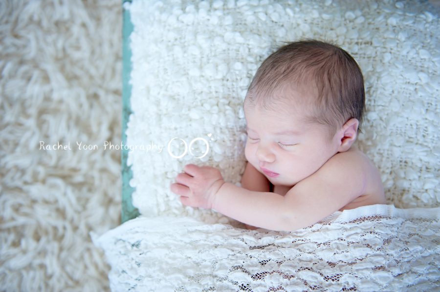 newborn photography vancouver - baby girl on a bed prop