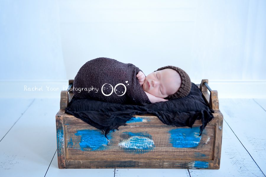 newborn photography vancouver - newborn baby boy propped in a box