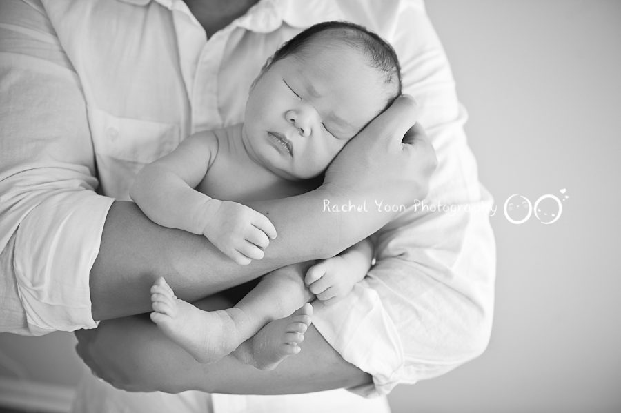 newborn in dad's arms - Newborn Photography Vancouver