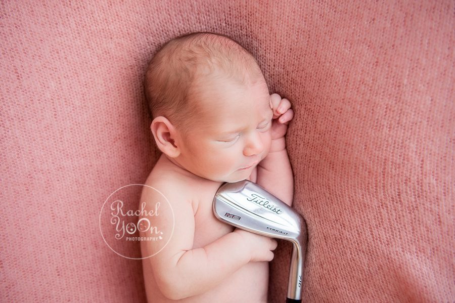 newborn baby girl holding golf club