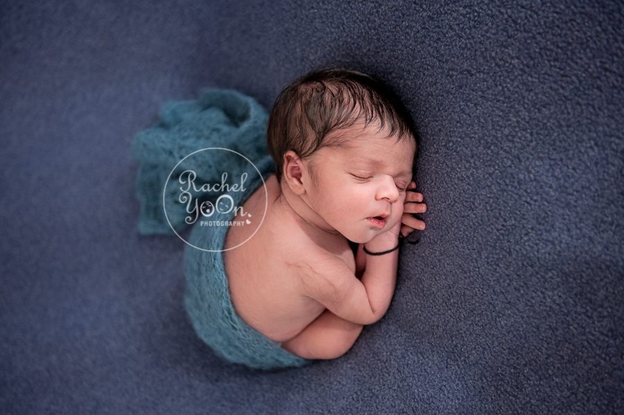 newborn baby boy wrapped in a blue wrap - newborn photography vancouver
