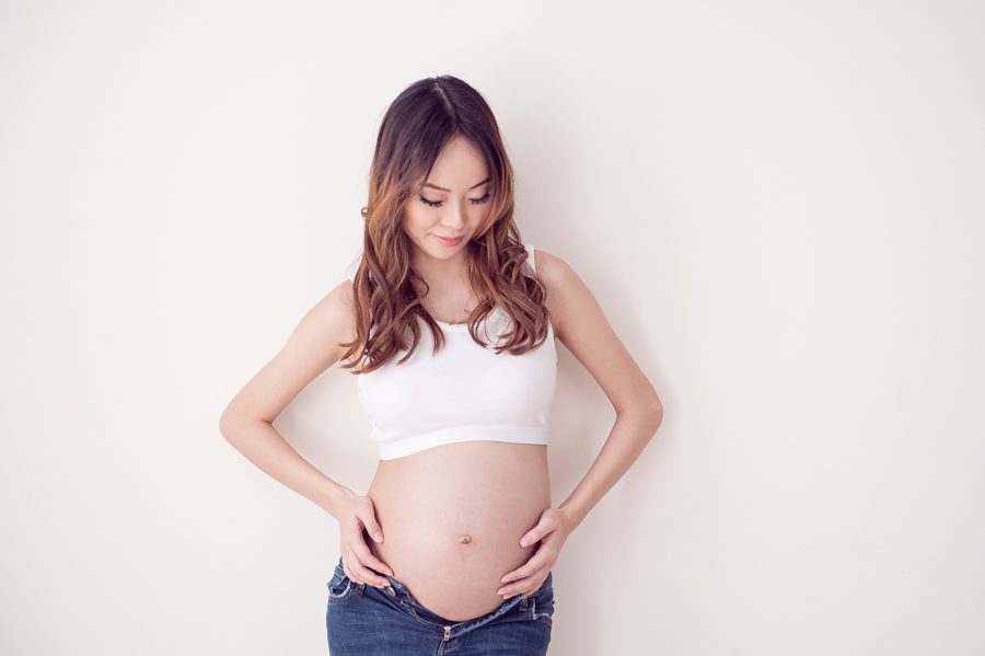 maternity pose in casual jeans - maternity photography vancouver