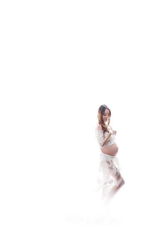 maternity pose in a lovely white dress with backlighting - maternity photography vancouver
