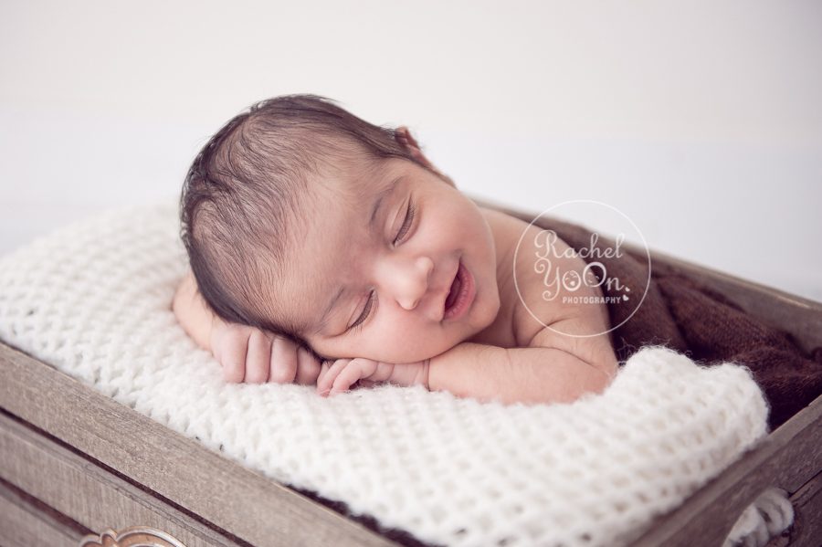 newborn baby girl smiling in the garden basket - newborn photography vancouver