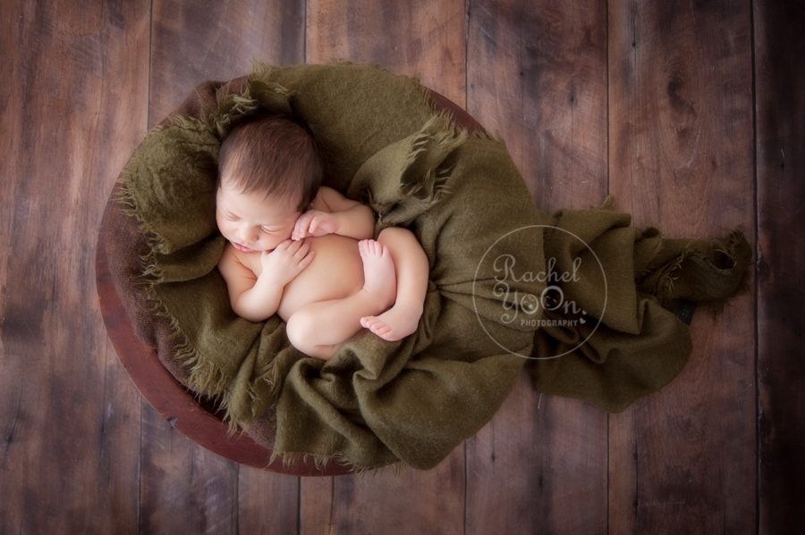 newborn baby boy in a wooden basket - newborn photography vancouver