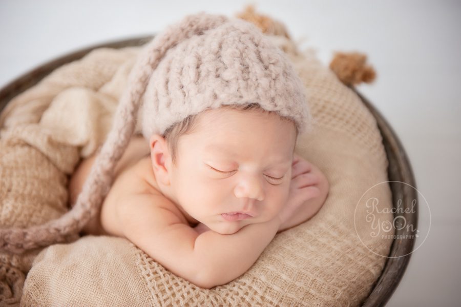 newborn baby boy in a metal basket - newborn photography vancouver