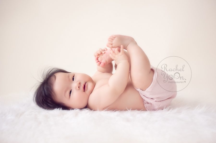 baby girl holding her toes - baby photography vancouver