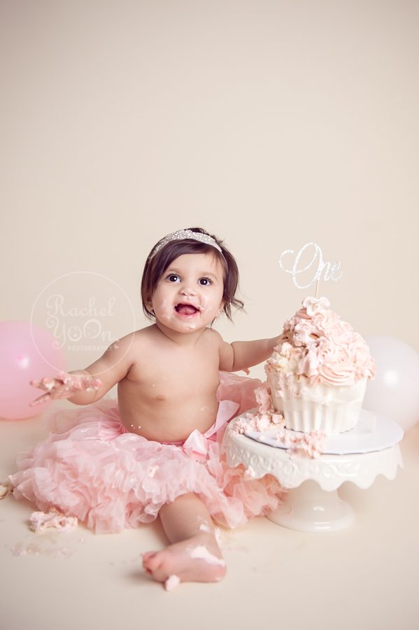 1 year old baby girl doing a cake smash - baby photography vancouver