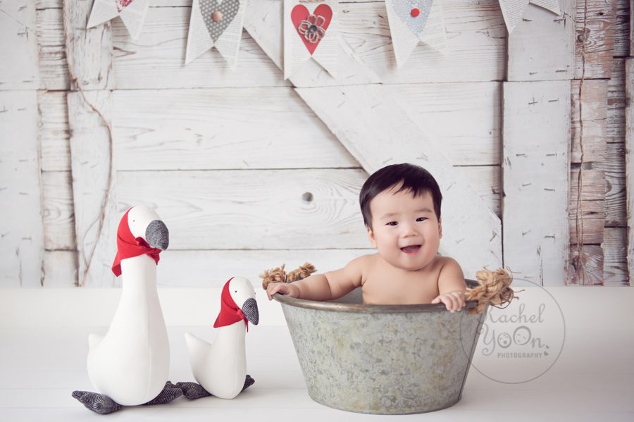 6 months old baby boy sitting in a bucket - baby photography vancouver