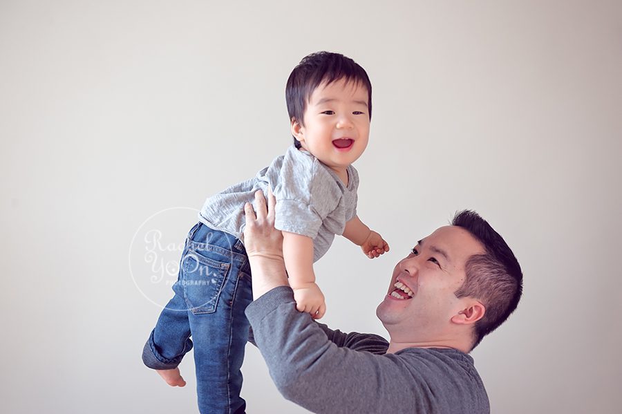 1 year old baby boy lifted by his dad - baby photography vancouver