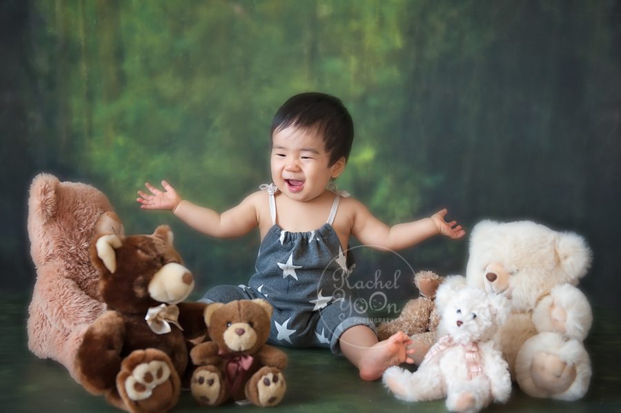 1 year old baby boy having fun with teddy bears - baby photography vancouver