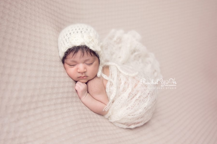 newborn baby girl wrapped in white and wearing a bonnet - newborn photography vancouver