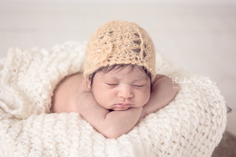 newborn baby girl with a bonnet - newborn photography vancouver