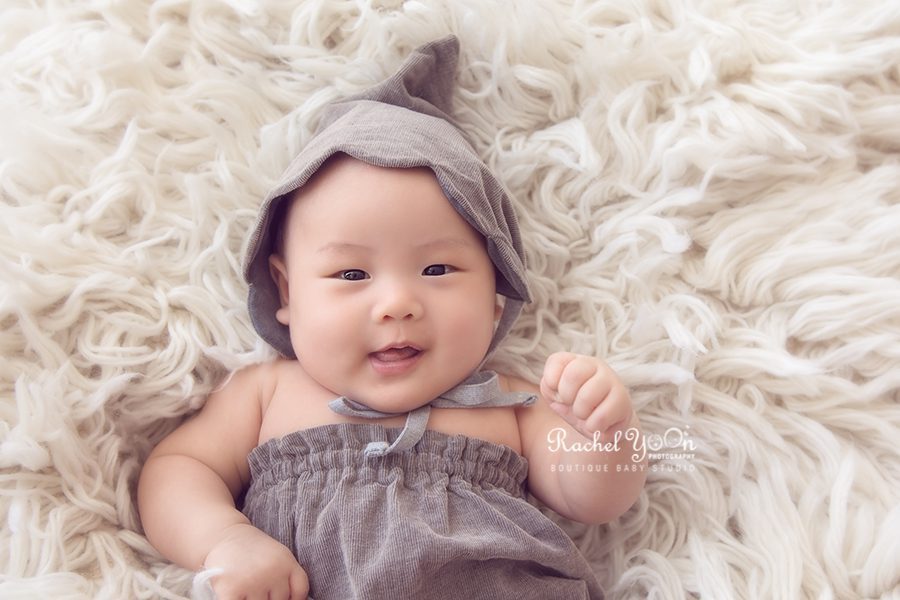 baby in romper and hat - Vancouver Baby Photography for 100 days