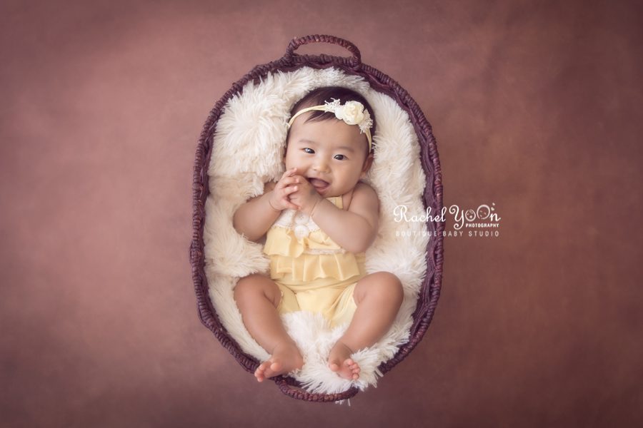 100 days old baby smiling in a basket - Baby Photography Vancouver