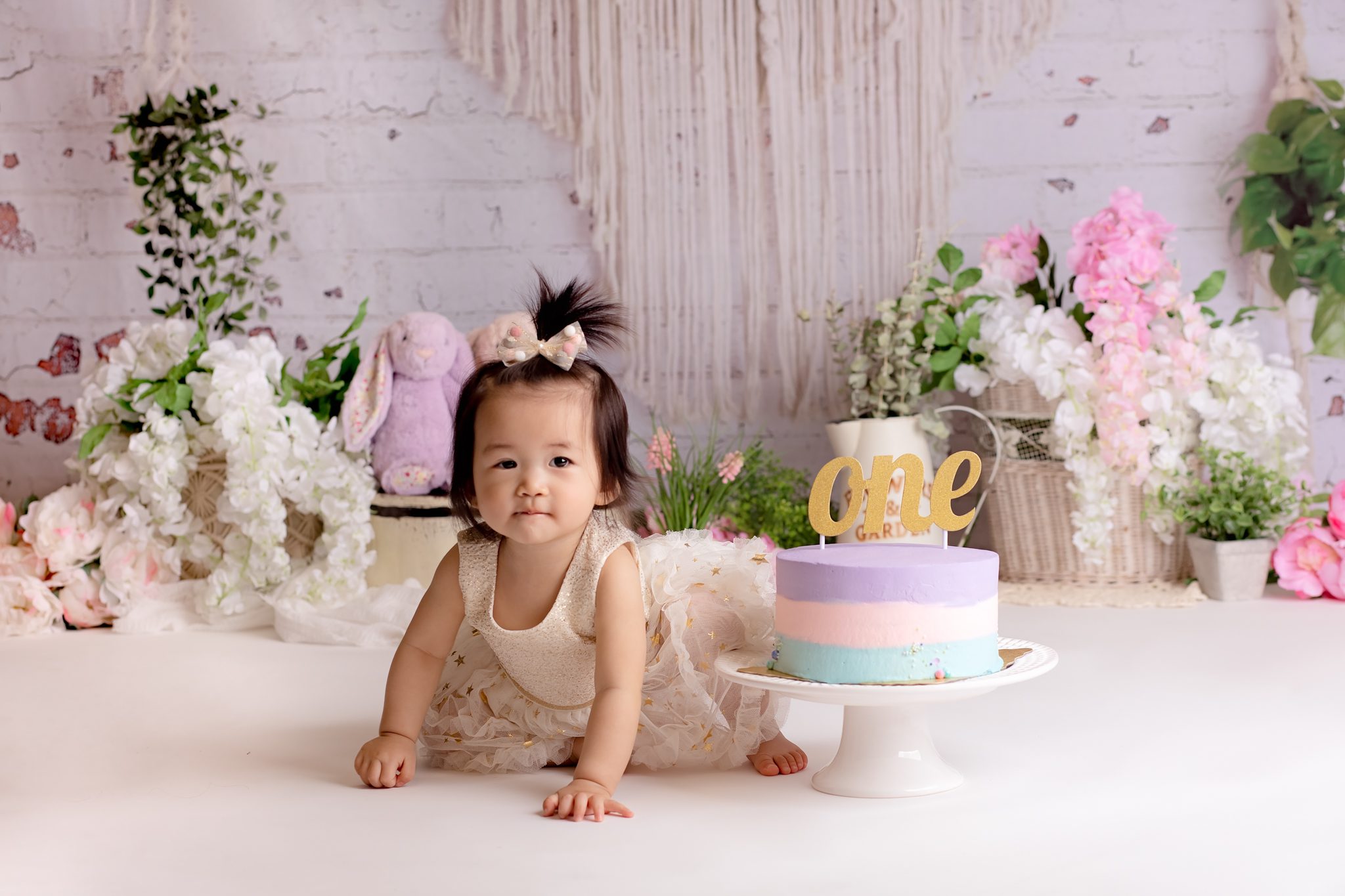 baby girl cake smash with boho background with touch of flowers