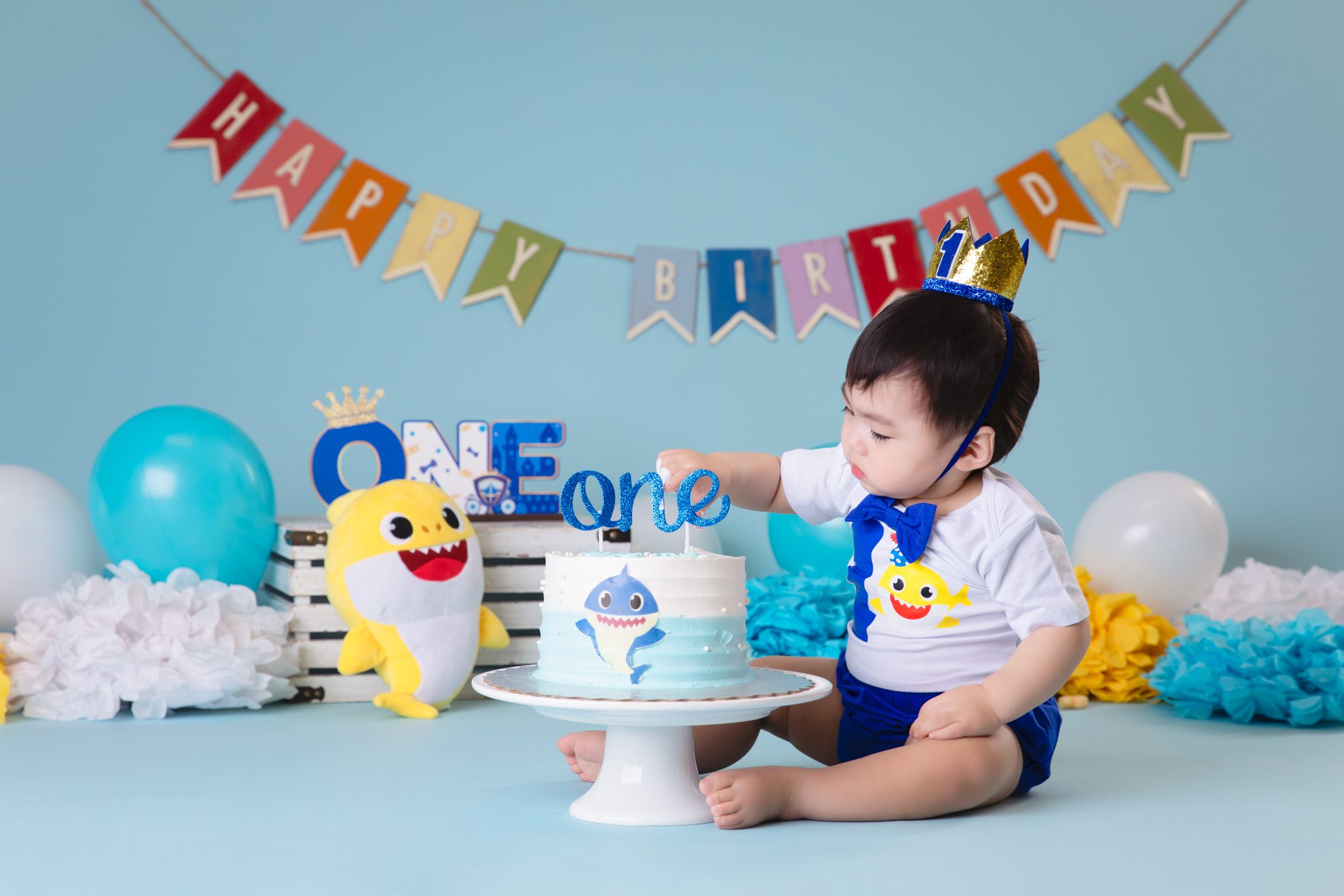 blue themed cake smash session for a baby boy
